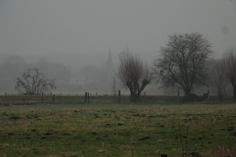 Die Zierker Kirchturmspitze taucht im fernen Nebel auf